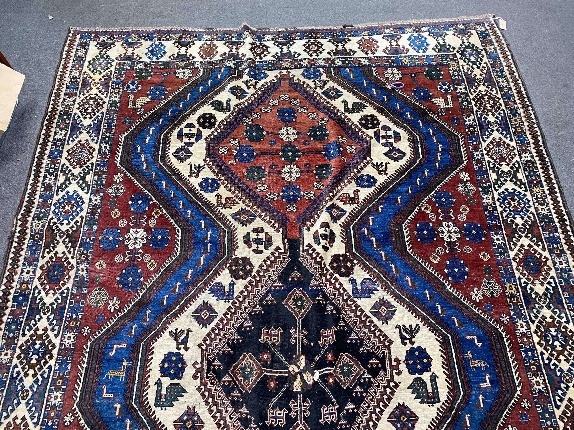 A Caucasian red ground carpet, 335 x 214cm
